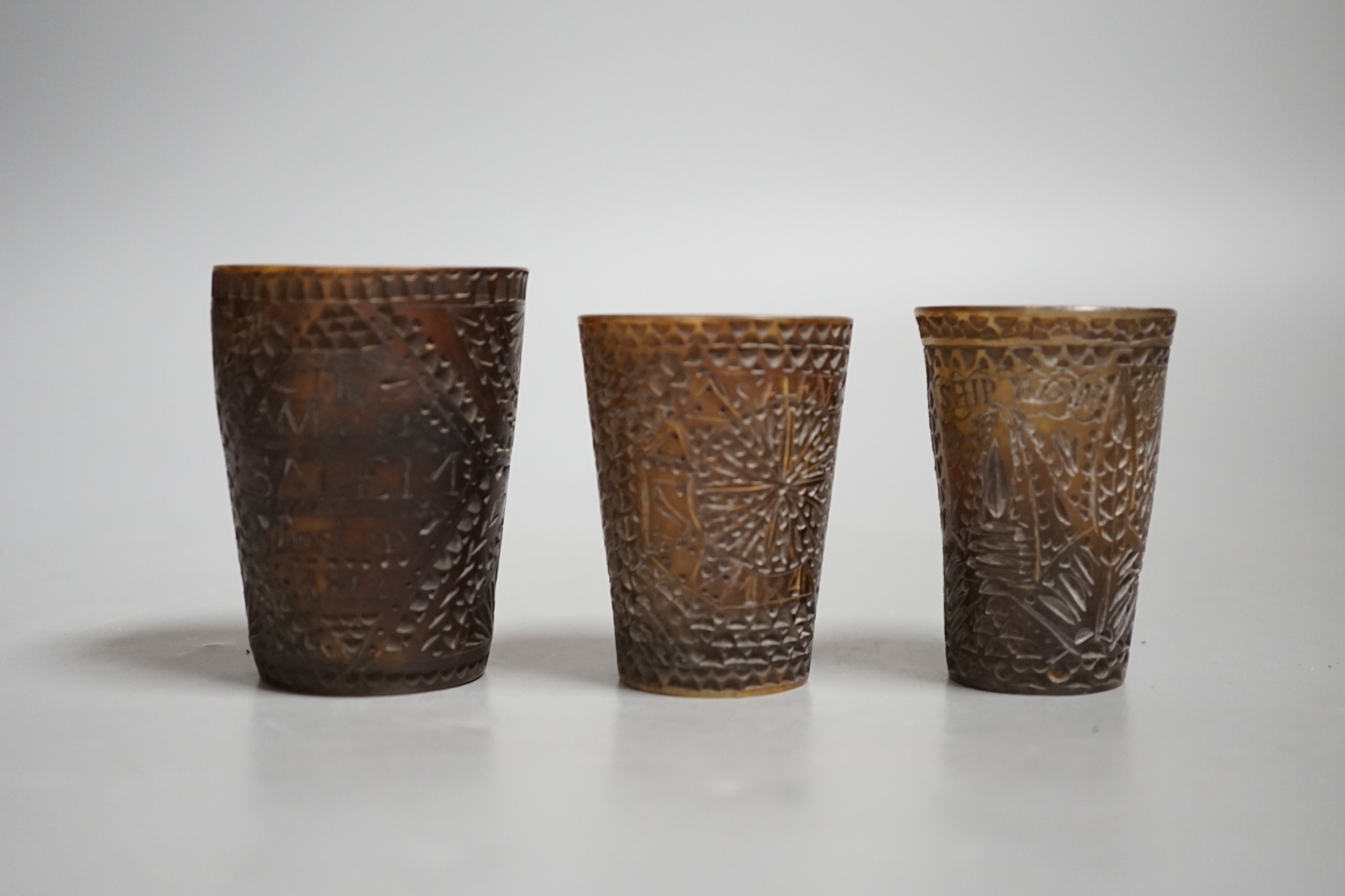 Three 19th century scrimshaw carved baleen cups. All inscribed and dated, Tallest 7cm